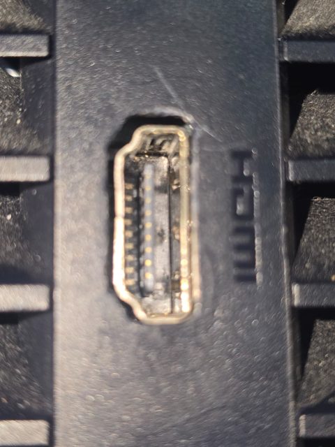 Close-up of a PS5 HDMI port on a console that came in with heat damage