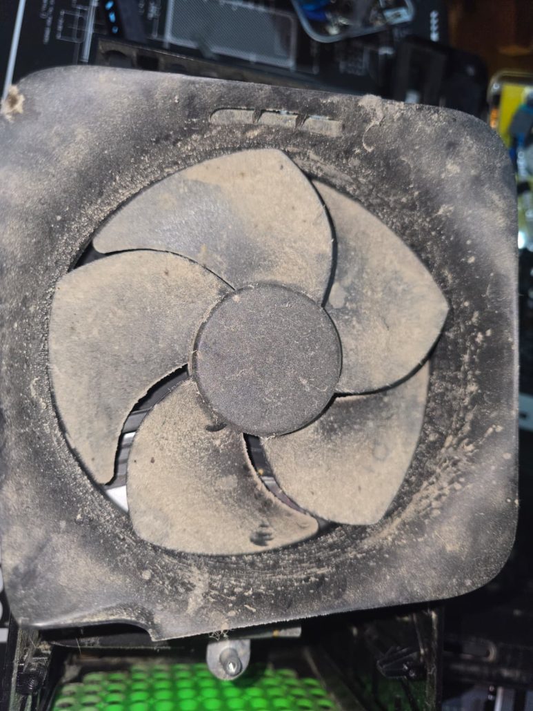 Xbox console fan blades and housing coated in thick dust