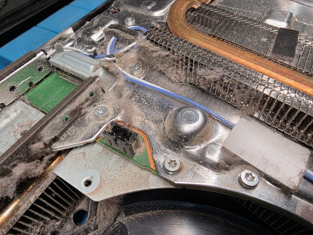 Dust building up around the heat pipes and heatsink inside a PS5