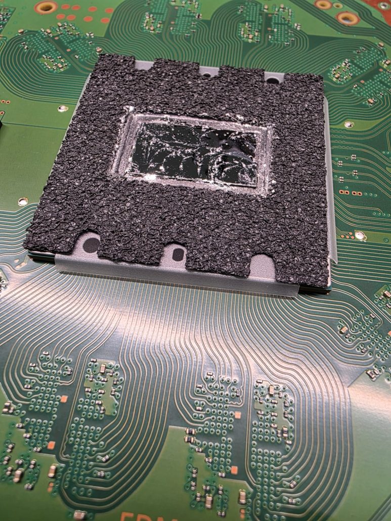 PS5 processor with its protective foam ring and liquid metal residue on the die