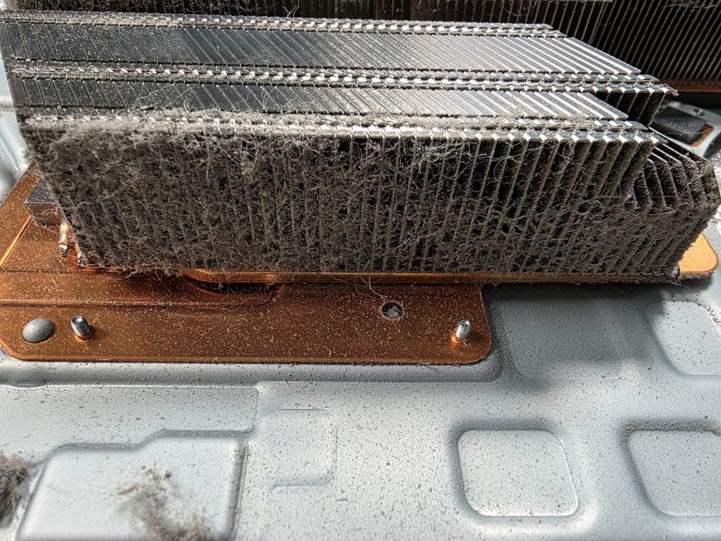 PS5 heatsink with copper base and dust built up between the fins