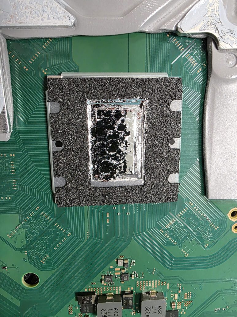 PS5 processor inside its foam ring with old liquid metal residue before cleaning