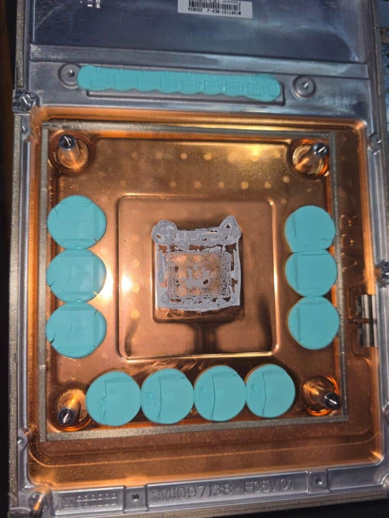Xbox cooling plate with teal thermal pads and old thermal compound on the processor contact area