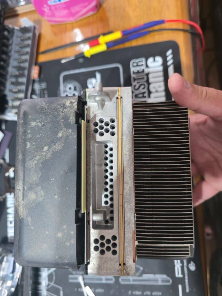 Xbox console fan shroud and heatsink covered in a layer of dust