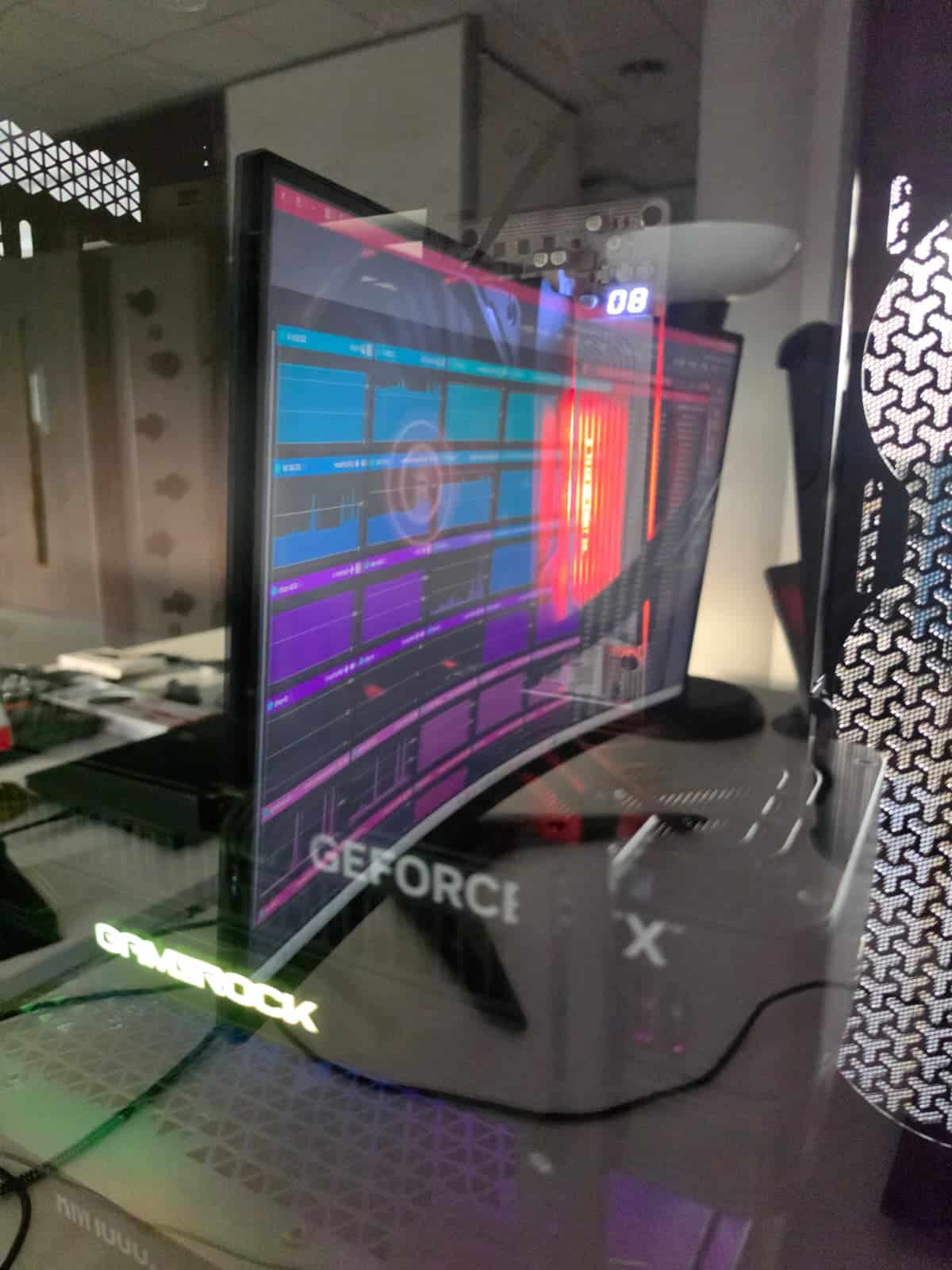 Curved monitor and RGB glass PC case seen from the side