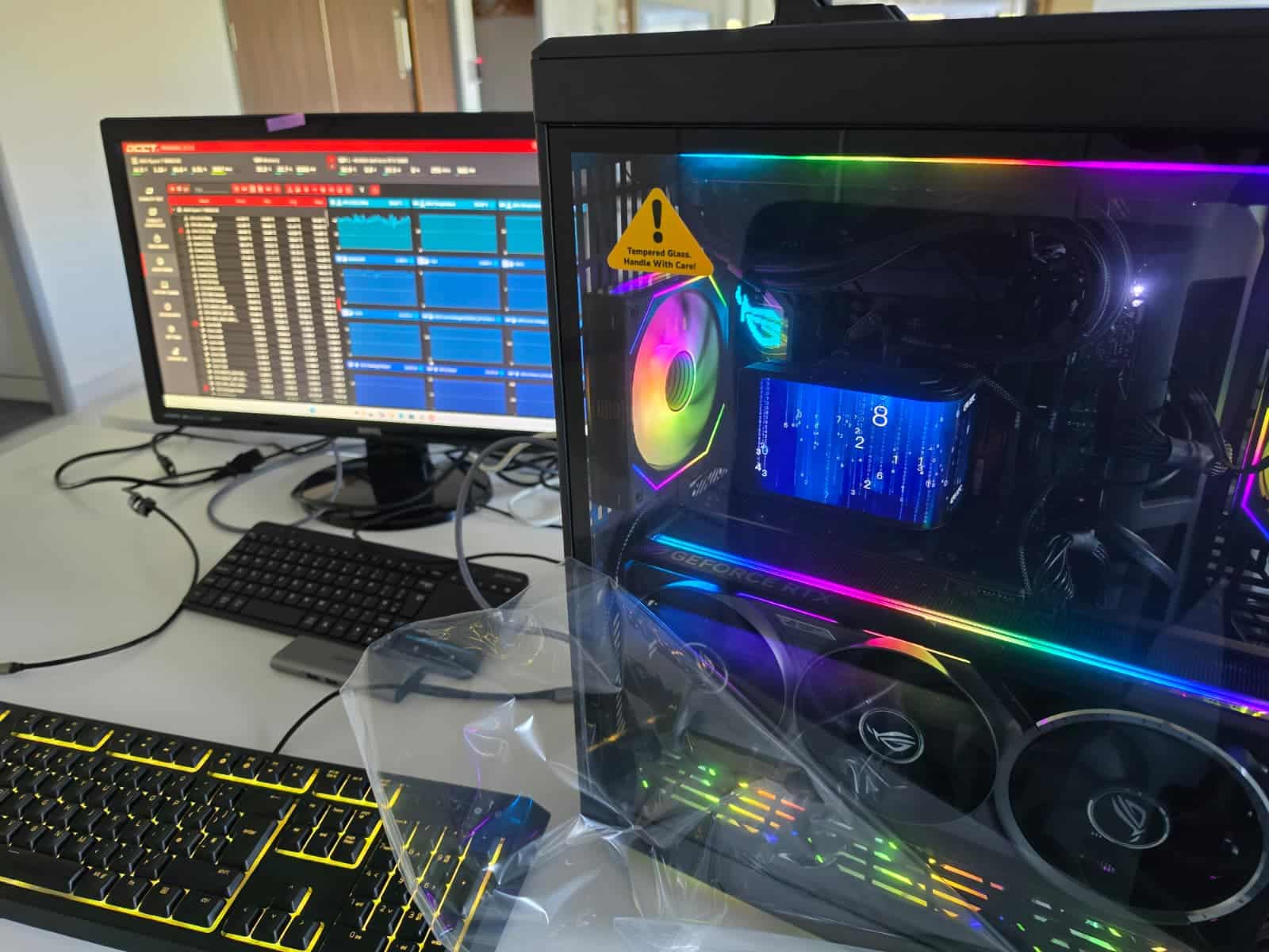 Custom gaming PC with RGB graphics card lighting, monitor and keyboard
