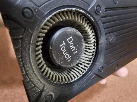 Graphics card blower fan with dust packed between the blades