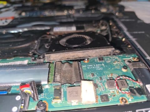 Laptop fan housing and heatsink full of dust and lint