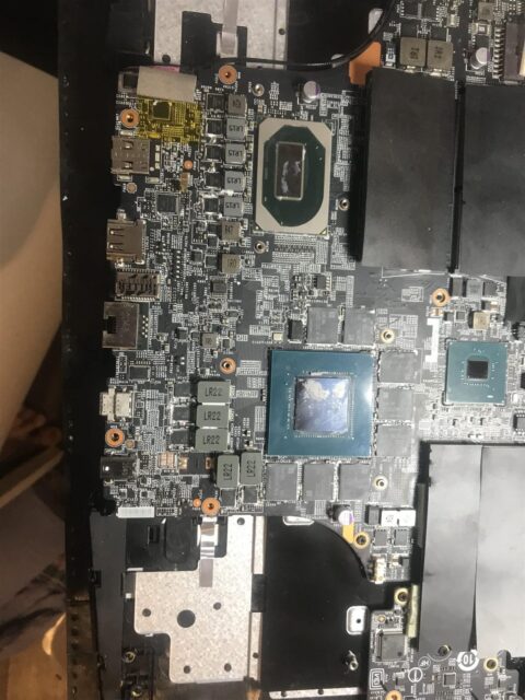 Close-up of a gaming laptop graphics chip with the memory and power components around it that take thermal pads