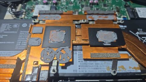 Underside of a gaming laptop heatsink with old thermal paste on the copper plates and worn thermal pads for the memory and power parts