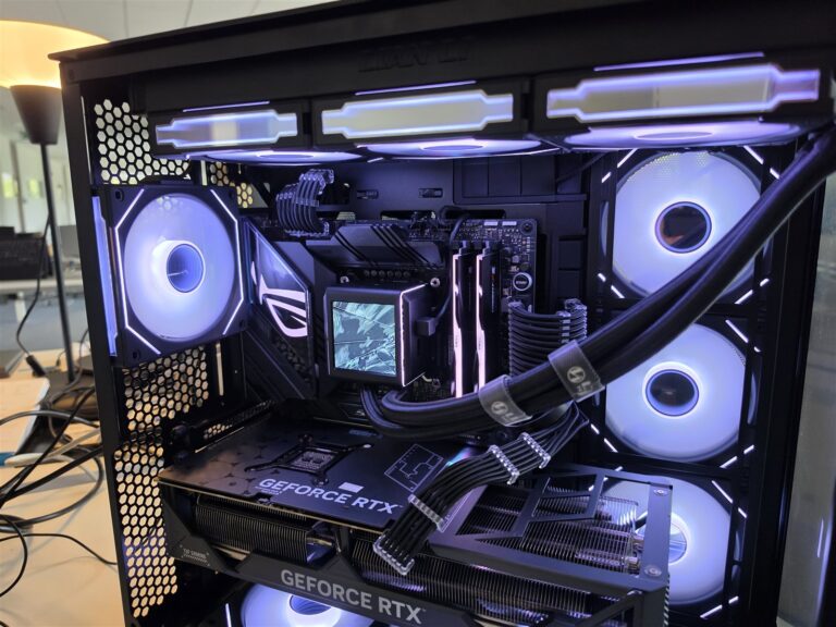 Lian Li O11 Vision custom PC build, side view with white fans and lighting, GeForce RTX graphics card and liquid cooling