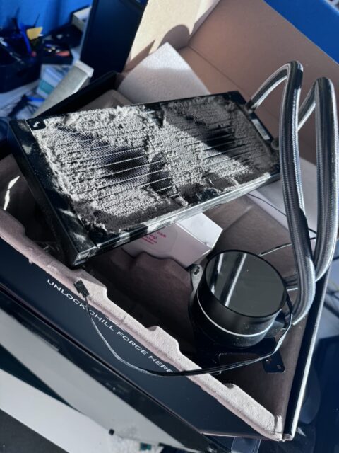 Liquid CPU cooler radiator with a thick layer of dust between the fins