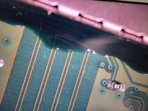 Microscope view of the HDMI signal tracks on an Xbox motherboard during trace repair