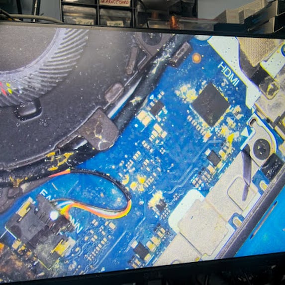 Liquid residue near the fan area of a laptop motherboard