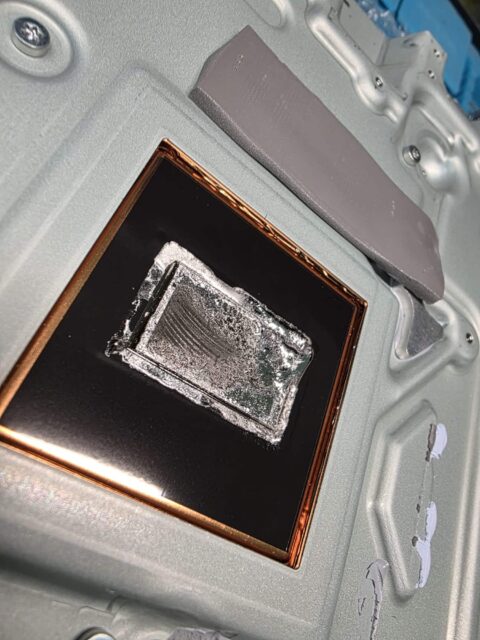 PS5 heatsink contact plate with liquid metal residue and a bead of liquid metal