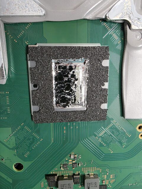 PS5 processor inside its foam ring with old liquid metal residue before cleaning