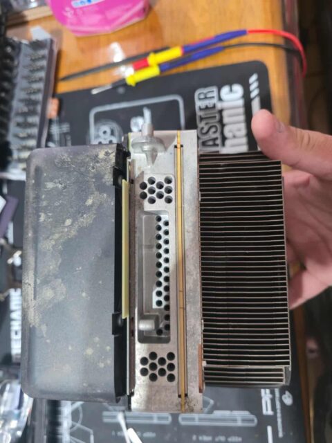 Xbox console fan shroud and heatsink covered in a layer of dust