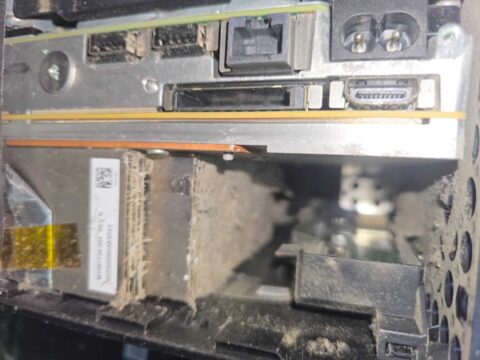 Xbox ports and HDMI connector above a heatsink clogged with dust and fibres